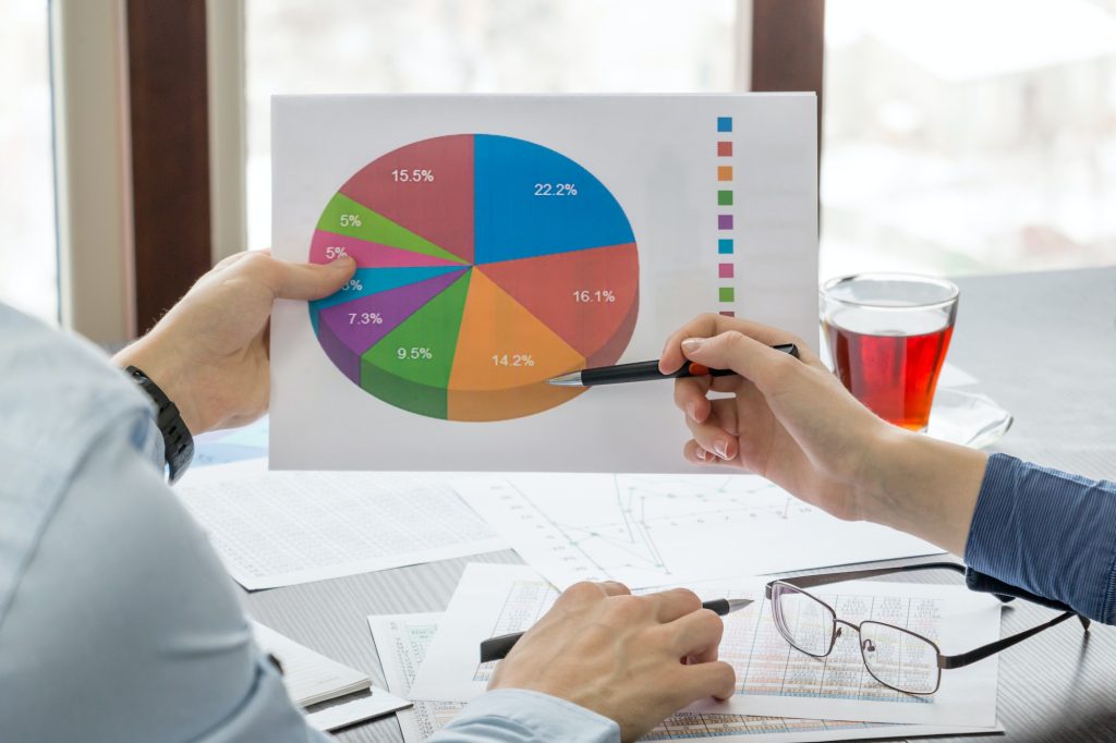 pie chart in the hands of young people closeup